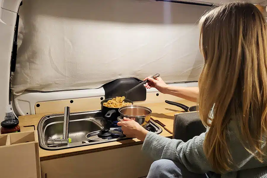 Bei schlechterem Wetter oder Abends kann auch gut drinnen gekocht werden. Ganz gemütlich im Sitzen funktioniert das, wenn Sitz- und Rückenpolster unmittelbar hinter der Kochgelegenheit beiseite gelegt werden und man so vom Einzelsitz aus arbeiten kann.