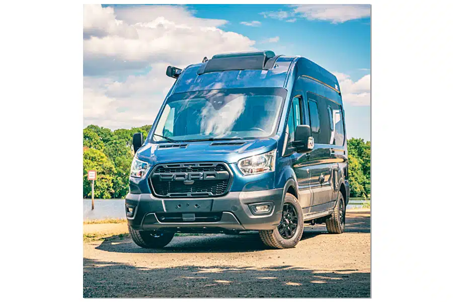 Blauer Pilote Atlas Campervan an einem Gewässer fotografiert