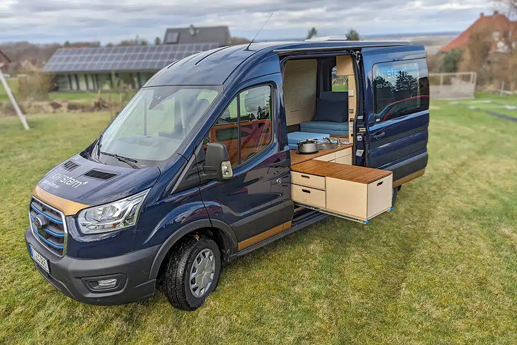 Lightstern Polaris: Dunkelblauer Ford-Transit-Campervan auf eienr Wiese