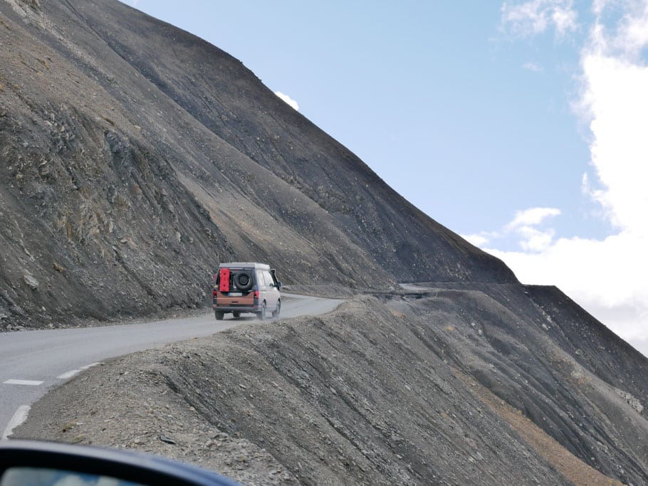 Ein Fahrzeug auf einer Bergstraße, der Berg ist steinig und ohne jedlichen Pflanzenbewuchs