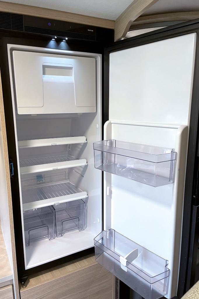 Geöffneter Kühlschrank mit großem Eisfach oben, das man herausnehmen kann.